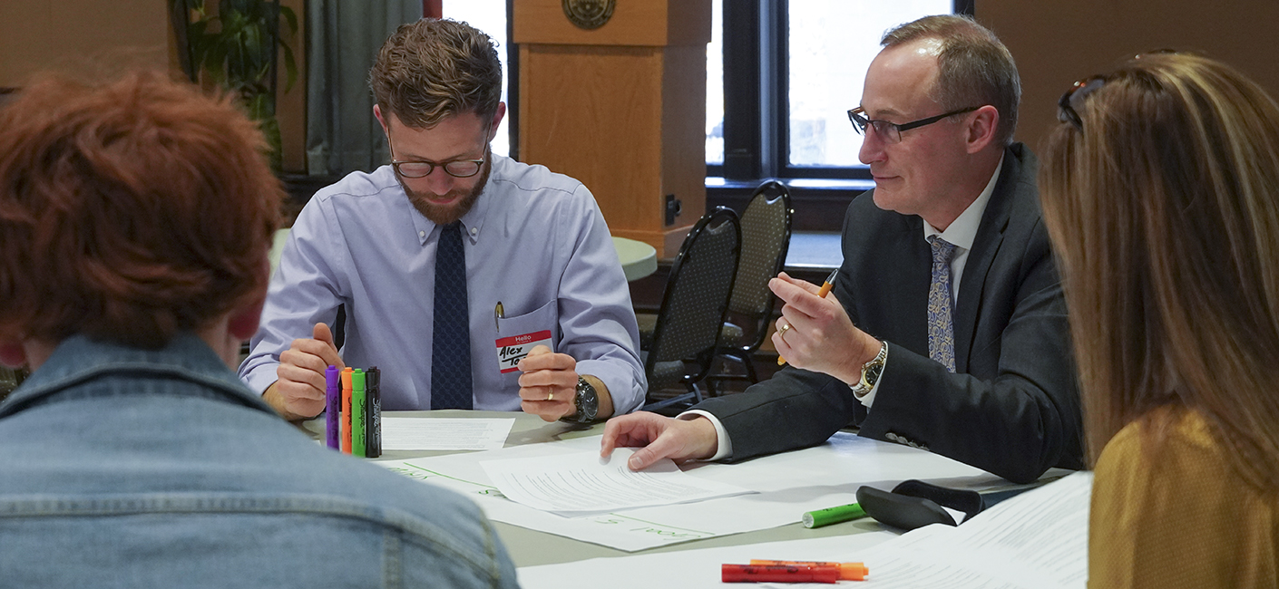 Alex Toner (left), assistant director of community engagement in the Office of Community and Governmental Relations, works with Randall McCready, executive director of financial aid in the Office of Admissions and Financial Aid, during a recent Plan for Pitt workshop.
